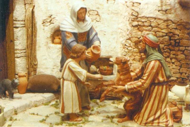 Detalle de un diorama realizado por Juan Giner y figuras a palillo de M. Castells, con san José sujetando a un perro con una herida en la pata derecha, que el Niño Jesús está lavando y la Virgen lleva un ánfora con agua