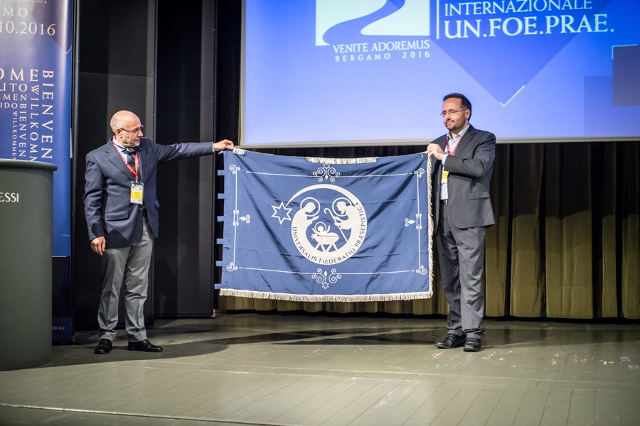 Presentación de la bandera de la Universalis Fœderatio Præsepistica (Un-Foe-Prae), con su nuevo isologo, durante la celebración del XX Congreso Belenista Internacional en Bérgamo (Italia)