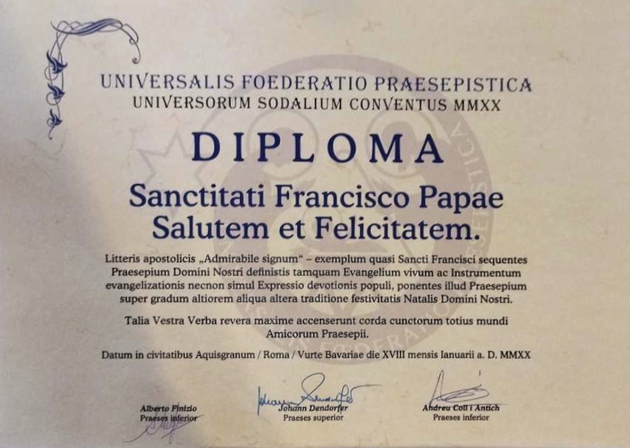 Diploma con la motivación de la concesión de la Distinción al Mérito Belenista Un.Fœ.Præ a Su Santidad el Papa Francisco durante el XXI Congreso Internacional Belenista, celebrado en Aquisgrán (Alemania) entre el 15 y el 19 de enero de 2020